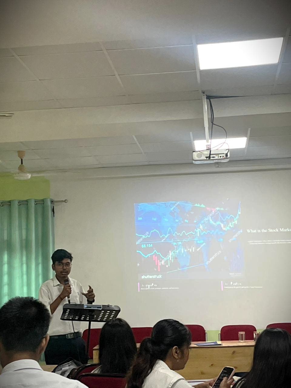 Professional presentation setting showing Koushik Kalita delivering a business presentation